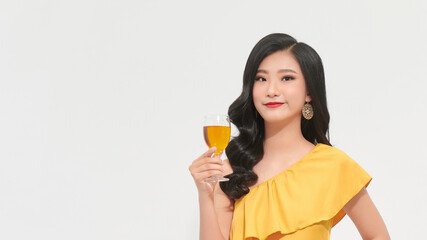 Young happy woman in yellow dress looking away and smiling with champagne isolated