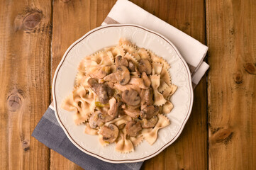 Butterfly pasta with mushrooms and parmesan sauce. Typical Italian cuisine from the south. Top view. Above. Copy space.