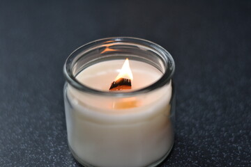 burning candles with wooden wick