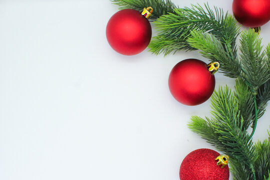 Christmas White Background Flat Lay With Red Ornament Balls And Decorations And The Christmas Tree