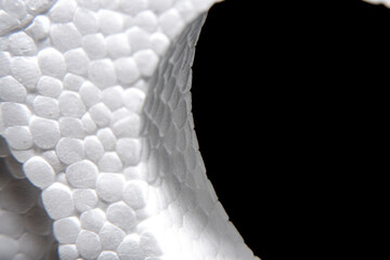A close-up of the uneven surface of the foam packaging in soft focus.