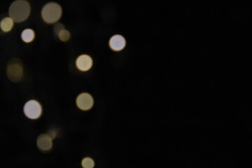 Christmas and New Years concept - defocused abstract multicolored bokeh lights background. Gold colors.
