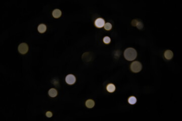 Christmas and New Years concept - defocused abstract multicolored bokeh lights background. Gold colors.
