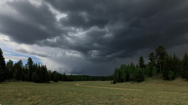 Time Lapse of dark and ominous storm clouds forming over a meadow.
