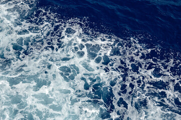Fototapeta premium blue sea surface with white foam