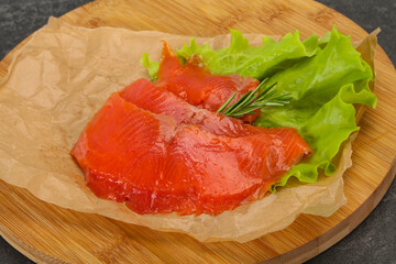 Sliced salmon fillet served rosemary