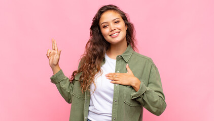  looking happy, confident and trustworthy, smiling and showing victory sign, with a positive...