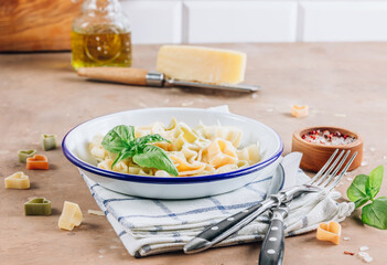 Heart-shaped pasta with basil leaves and parmesan