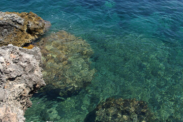 rocky coastline with dark blue sea background