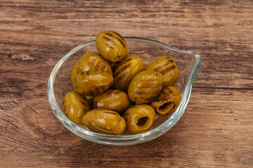 Green grilled olives in the bowl