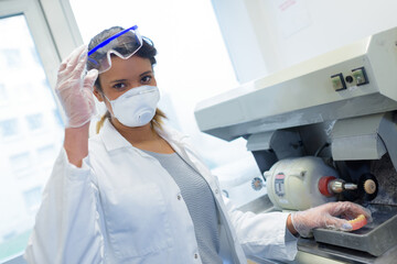 dental technician puts ceramics implant in milling machine