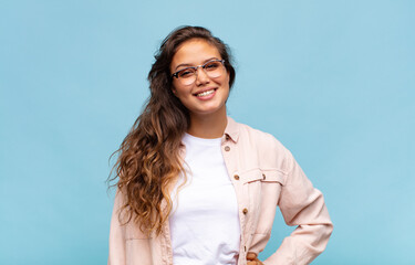  smiling happily with a hand on hip and confident, positive, proud and friendly attitude