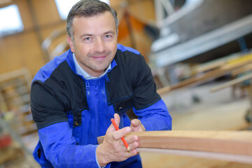 a boat builder is posing