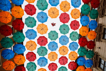 Fototapeta na wymiar Stockholm, Sweden Umbrellas grace the sky above Drottninggatan, a famous shopping street.