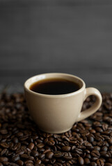 Obraz na płótnie Canvas Cup of coffee with roasted coffee beans background. Mug of black coffee.