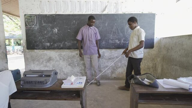 Teacher working with blind and partially sighted students. Africa