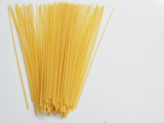 Raw dry spaghetti italian pasta spaghetti line, Yellow long spaghetti on white wooden background, Food background concept.