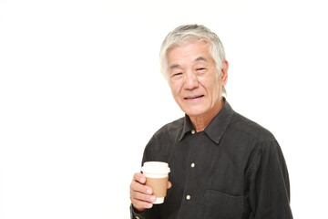 senior Japanese man takes a coffee break