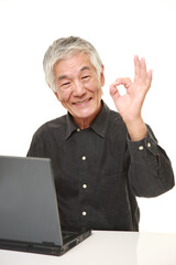 senior Japanese  man using laptop computer
