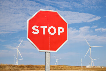 Obraz premium Stop signal and windmills