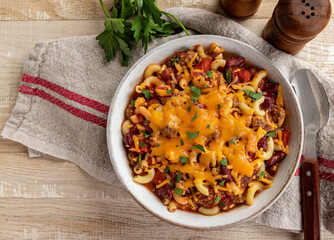 Bowl of chili mac with cheddar cheese