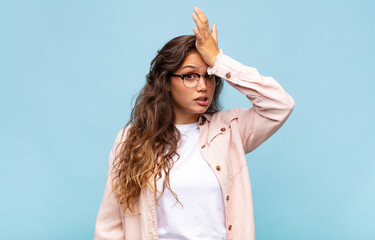  raising palm to forehead thinking oops, after making a stupid mistake or remembering, feeling dumb