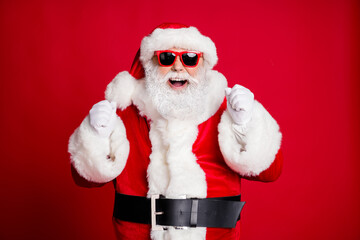 Portrait of his he nice handsome cheerful cheery glad bearded Santa father having fun celebratory rejoicing good luck win winner isolated bright vivid shine vibrant red color background