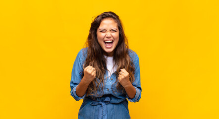  shouting aggressively with annoyed, frustrated, angry look and tight fists, feeling furious