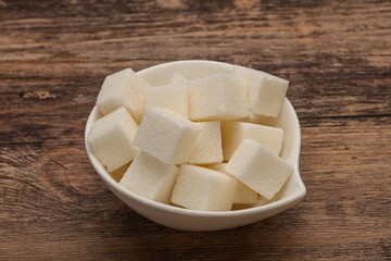 Refined white sugar cubs in the bowl