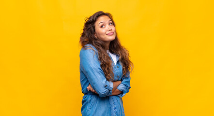  shrugging, feeling confused and uncertain, doubting with arms crossed and puzzled look