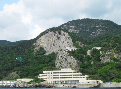 Crimea, Greater Yalta, Oreanda, July, 2018: sanatorium on the rocky shore of Oreanda, steep cliffs among green thickets    