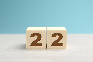 Wooden toy blocks forming the number 22.