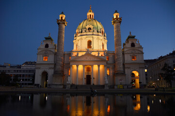 Fototapeta na wymiar Saint Charles Church at dusk with reflection in the pond , Vienna, Austria