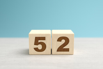 Wooden toy blocks forming the number 52.
