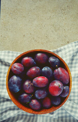 fresh plums on granite surface