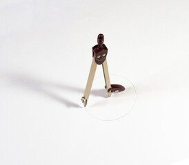 a compass draws a circle on a piece of Whatman paper. drawings, measurement accuracy, school.