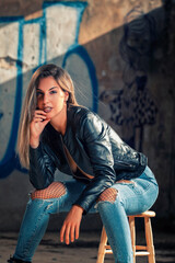 Model with leather jacket and blue jeans