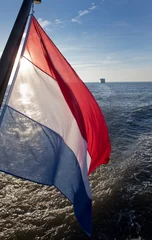 Gordijnen Sailing at Nortsea. Waddenzee.. Noordzee. Super sailing yacht. Netherlands. Dutch flag. © A