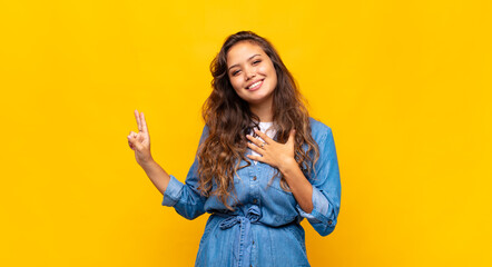  looking happy, confident and trustworthy, smiling and showing victory sign, with a positive...