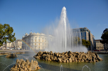  Schwarzenberg square with water fountain and rainbow in bright sunny day, Vienna, Austria