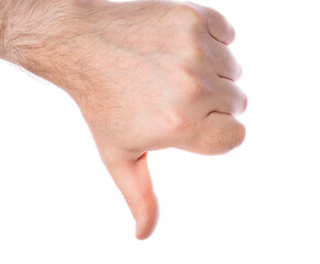 close-up of male hand with thumbs down on white background, disappointment disapproval concept.