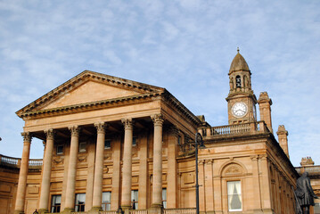 Classical Columns & Pediment on Facade of 19th Century Stone Public Building with Clock Tower 