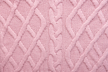 Knitted wool background. Pink texture knitted wool sweater