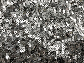 Silver sequins fabric pattern texture fashion background.