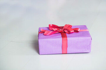 
Lilac gift box with pink packing tape.