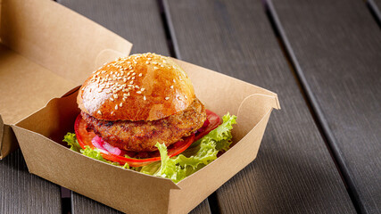 Street food. Meat cutlet burgers are in paper boxes. Food delivery.