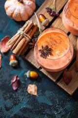Spicy cocktail, pumpkin smoothie with cinnamon, anise. Traditional autumn food.