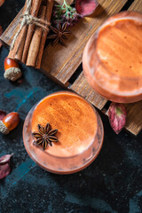 Spicy cocktail, pumpkin smoothie with cinnamon, anise. Traditional autumn food.