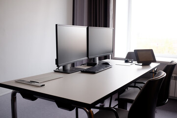workplace with computers on the table in an empty office. work Desk for a creative business team in a modern office