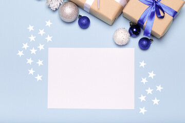 Empty christmas card on blue, Christmas blue background with decorations, gift box and balls.